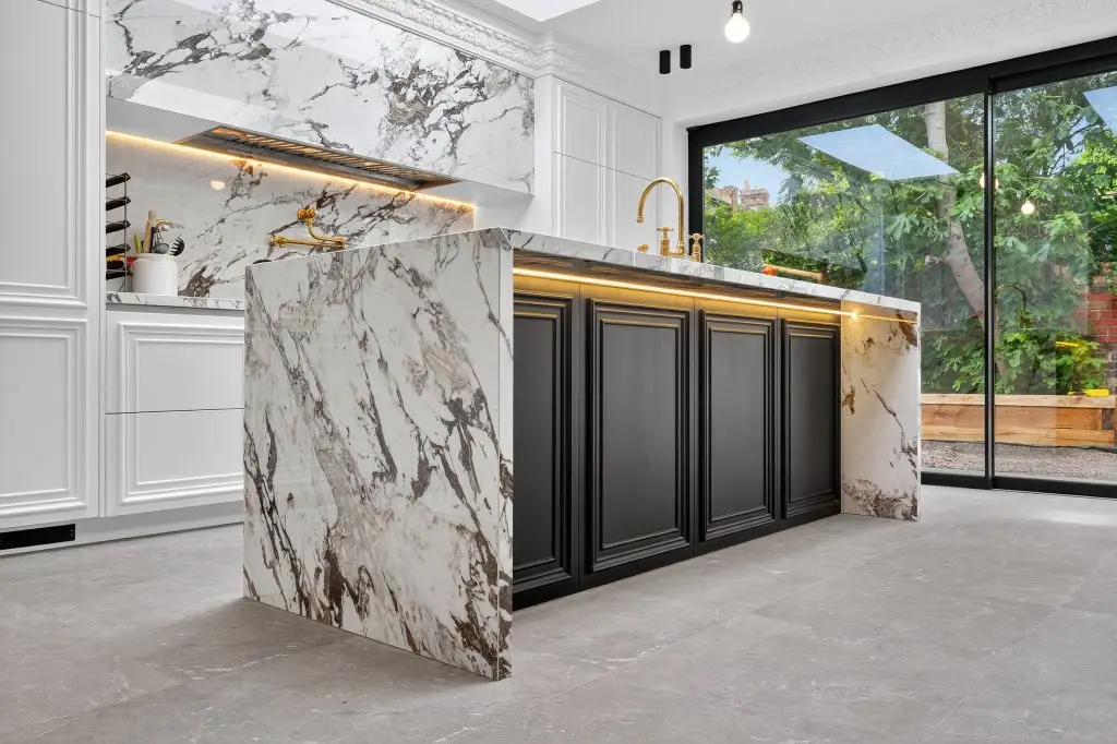 Custom kitchen island with natural stone worktop in Hampstead home