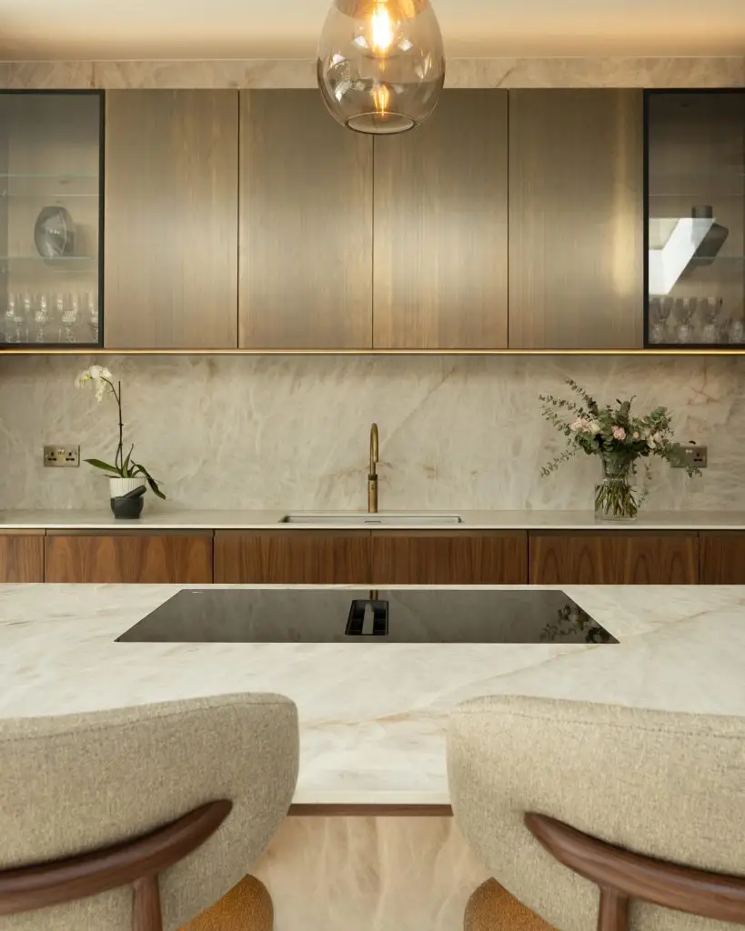 Glazed aluminium framed kitchen cabinets with integrated lighting and metallic Oxibronze finish