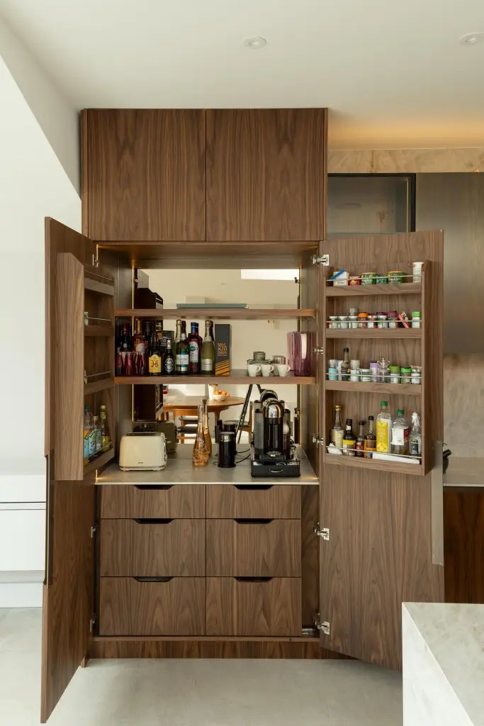 Bespoke kitchen pantry with mirrored interior and intelligent storage in a Winchmore Hill home